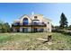 Stunning two-story home with a balcony, large windows, and a lush yard perfect for outdoor living and entertainment at 1120 Brenthaven Ct, Monument, CO 80132