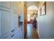 Charming hallway with built-in cabinets, hardwood floors, and arched doorways leading to different areas of the home at 1120 Brenthaven Ct, Monument, CO 80132
