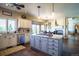 Bright kitchen features stainless appliances, a granite island with seating, modern lighting, and wood floors throughout at 1120 Brenthaven Ct, Monument, CO 80132