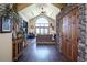Open-concept living room with hardwood floors and stone accent walls, blending rustic charm with modern elegance at 1120 Brenthaven Ct, Monument, CO 80132