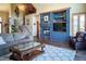Inviting living room with cozy fireplace, plush seating, and decorative built-ins and an adjoining staircase to the second level at 1120 Brenthaven Ct, Monument, CO 80132