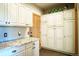 Pantry with ample cabinet space, granite countertops, and hardwood floors, designed for organized storage and functionality at 1120 Brenthaven Ct, Monument, CO 80132