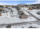 A wintery aerial view of the neighborhood showcasing snow-covered houses and landscape at 19814 Lindenmere Dr, Monument, CO 80132