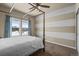 Cozy bedroom with a four-poster bed, neutral colors, and natural light from the windows at 19814 Lindenmere Dr, Monument, CO 80132