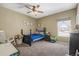 This bedroom has natural light, carpet floors and a ceiling fan at 19814 Lindenmere Dr, Monument, CO 80132