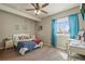 Charming bedroom has lots of natural light and a large window with bright blue curtains at 19814 Lindenmere Dr, Monument, CO 80132