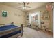 Bedroom features window bench and ceiling fan and is decorated in a sports theme at 19814 Lindenmere Dr, Monument, CO 80132