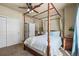 Bedroom features a four-poster bed, neutral colors, and a closet with a ceiling fan at 19814 Lindenmere Dr, Monument, CO 80132