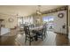 Open concept dining room with large windows, slider, modern light fixture, and hardwood flooring at 19814 Lindenmere Dr, Monument, CO 80132