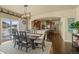 Open dining area with natural light and view into the kitchen. Modern light fixture overhead at 19814 Lindenmere Dr, Monument, CO 80132