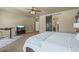 Large main bedroom featuring carpeted floors, barn door to bathroom, and ceiling fan at 19814 Lindenmere Dr, Monument, CO 80132