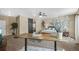 Relaxing bedroom with a barn door to bathroom, carpeted floors and ceiling fan at 19814 Lindenmere Dr, Monument, CO 80132