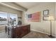 This home office boasts natural light, a large wooden desk, and an American flag decoration at 19814 Lindenmere Dr, Monument, CO 80132