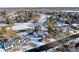 Aerial view of home with mature trees and snow-covered yard and golf course in the background at 78 Fairway Ln, Littleton, CO 80123