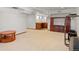Large finished basement with kitchenette, entertainment area, and exercise equipment at 78 Fairway Ln, Littleton, CO 80123