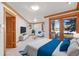 Spacious bedroom featuring a walkout balcony, and stylish furnishings at 78 Fairway Ln, Littleton, CO 80123