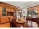 Elegant dining room featuring hardwood floors, decorative built-in cabinets, and large windows for ample natural light at 78 Fairway Ln, Littleton, CO 80123