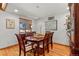 Bright dining room with hardwood floors, wooden table, six chairs, and a window letting in natural light at 78 Fairway Ln, Littleton, CO 80123