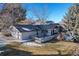 An exterior view of a single-Gathering home with a grey roof, partial snow cover, and a two-car garage at 78 Fairway Ln, Littleton, CO 80123