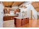 Well-equipped kitchen boasts cherry cabinets, an island with bar seating, and modern appliances at 78 Fairway Ln, Littleton, CO 80123