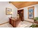 Well-lit office with wood desk and ample storage provides a great work-from-home space at 78 Fairway Ln, Littleton, CO 80123