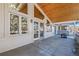 A covered patio with a wooden ceiling, lots of windows, concrete flooring, and a fireplace at 78 Fairway Ln, Littleton, CO 80123