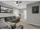 Basement featuring a gray sectional, neutral carpet, mirror, sports memorabilia, and neutral walls at 6476 Silver Mesa Dr # A, Highlands Ranch, CO 80130