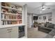 Basement featuring a gray couch, shelving, sports memorabilia, wine fridge, and neutral walls at 6476 Silver Mesa Dr # A, Highlands Ranch, CO 80130