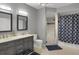 Stylish bathroom featuring dual vanities, a walk-in shower, and modern fixtures at 6476 Silver Mesa Dr # A, Highlands Ranch, CO 80130