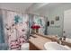Bathroom featuring a vanity, sink, toilet, and tub with flower shower curtain at 6476 Silver Mesa Dr # A, Highlands Ranch, CO 80130
