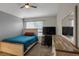 Bedroom featuring a bed, window, desk area and dresser with rustic wood at 6476 Silver Mesa Dr # A, Highlands Ranch, CO 80130