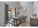 Bright dining room with decorative chandelier and sliding glass doors to outdoor patio space at 6476 Silver Mesa Dr # A, Highlands Ranch, CO 80130