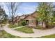 Charming townhome showcasing a manicured front yard, brick facade, and inviting walkway at 6476 Silver Mesa Dr # A, Highlands Ranch, CO 80130