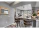 Charming kitchen with updated countertops and barstool seating area at 6476 Silver Mesa Dr # A, Highlands Ranch, CO 80130