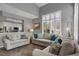 Open-concept living room with hardwood floors, bright windows, and comfortable seating at 6476 Silver Mesa Dr # A, Highlands Ranch, CO 80130