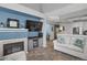 Cozy living room featuring a fireplace, mounted TV, and stylish decor at 6476 Silver Mesa Dr # A, Highlands Ranch, CO 80130