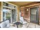 Cozy patio featuring outdoor seating, brick accents, and sliding door access at 6476 Silver Mesa Dr # A, Highlands Ranch, CO 80130