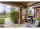 Covered patio showcasing brick pillars, a grill, and a comfortable seating area at 6476 Silver Mesa Dr # A, Highlands Ranch, CO 80130