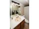 Well-lit bathroom featuring a vanity sink, mirror, and neutral color palette at 14991 E Elk Pl, Denver, CO 80239
