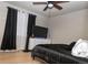 Comfortable bedroom with a ceiling fan and stylish decor at 14991 E Elk Pl, Denver, CO 80239