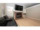 Inviting living room with a cozy fireplace and neutral color palette at 14991 E Elk Pl, Denver, CO 80239