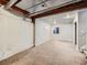 Unfinished basement with exposed ceiling, painted walls and carpet flooring at 378 Benton St, Castle Rock, CO 80104