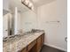 Bathroom featuring granite countertops, mosaic backsplash and dark tile flooring at 378 Benton St, Castle Rock, CO 80104
