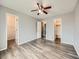 Bedroom featuring hardwood floors, neutral paint, and access to the bathroom at 378 Benton St, Castle Rock, CO 80104