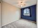 Bedroom features neutral carpet, blue accent wall and ceiling fan at 378 Benton St, Castle Rock, CO 80104