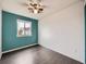 Bright bedroom with updated flooring, blue accent wall and ample light at 378 Benton St, Castle Rock, CO 80104