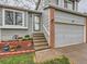 The exterior features a welcoming entrance with a gray door, brick accents, and landscaped details at 378 Benton St, Castle Rock, CO 80104