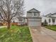 Charming gray two-story home with a well-manicured lawn, brick accents, and attached two-car garage at 378 Benton St, Castle Rock, CO 80104