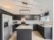 Modern kitchen with black cabinetry, stainless steel appliances, granite countertops, and island at 378 Benton St, Castle Rock, CO 80104