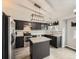 Modern kitchen featuring black cabinets, stainless steel appliances, granite countertops, and stylish lighting fixtures at 378 Benton St, Castle Rock, CO 80104